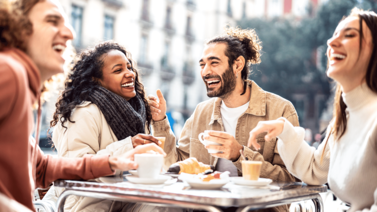 4 people smiling and having breakfast